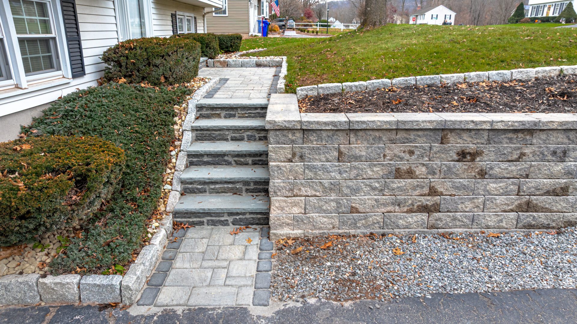 Engineered stone stairs and tiered retaining wall system in Cheshire, CT